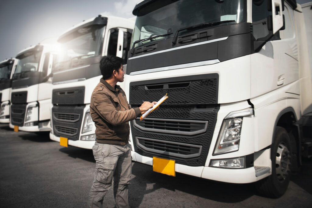 Person-inspecting-fleet-of-trucks